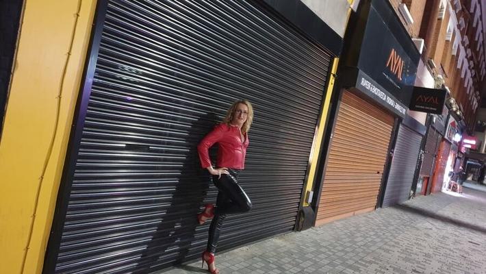 Leather clad street whore outside the sex club in London