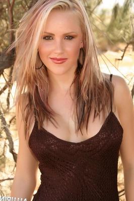 Blonde girl Steph shows off her perfect body in a net dress outdoors