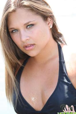 Lili Jensen has some fun in the ocean in a tiny bikini