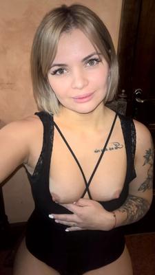 Short-haired hottie shows her small perky tits