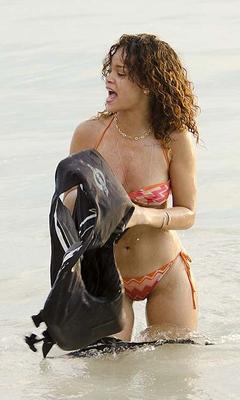 Rihanna posing and showing her sexy ass in bikini on beach
