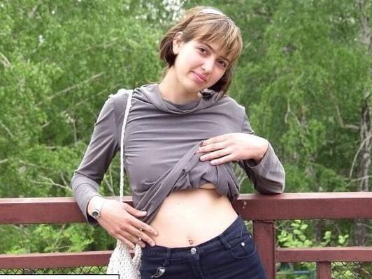 Naked cute girl near railroad