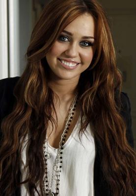 Miley Cyrus showing huge cleavage and great legs in some photoshoot