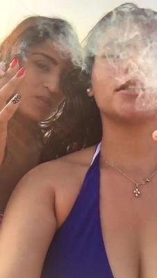 Smoking Kelly Cuesta on beach with lez gf