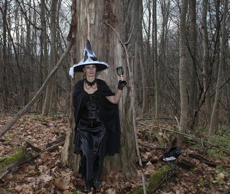 Witch with broom in forest