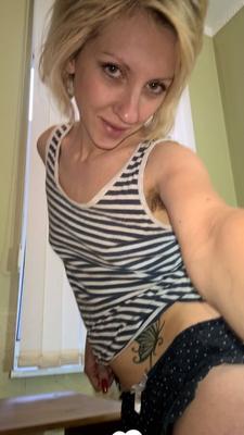 Cute blonde shows her tattoo and bush