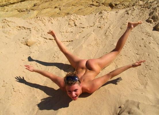Lovely blonde with sexy body posing on beach