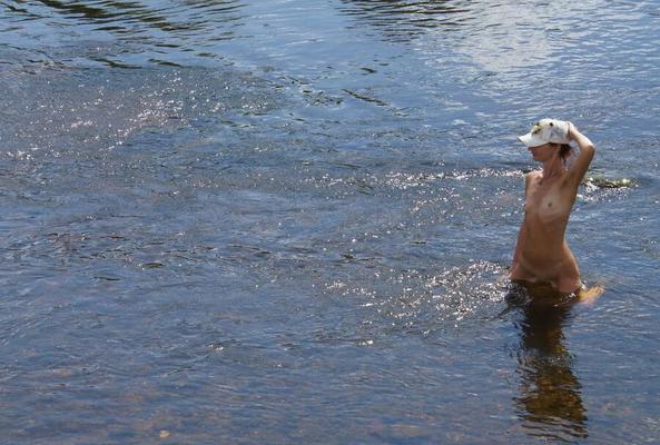 Nude in river's water