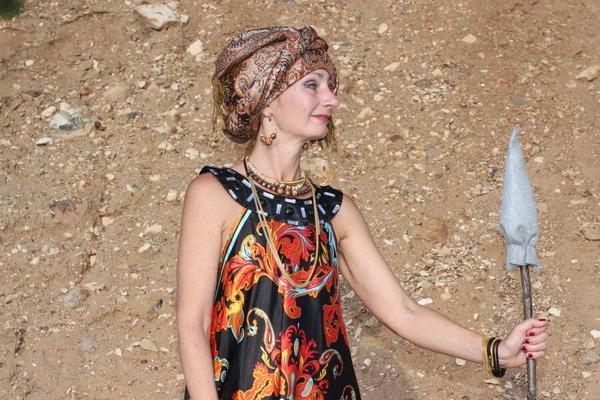 With Pear in Colorful Dress on Sand
