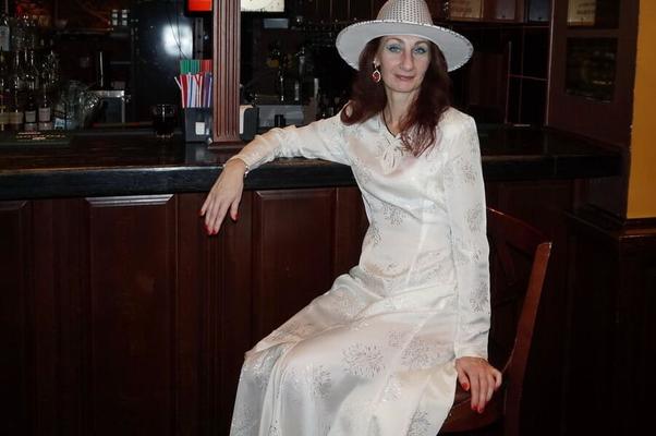 In Wedding Dress and White Hat on stage