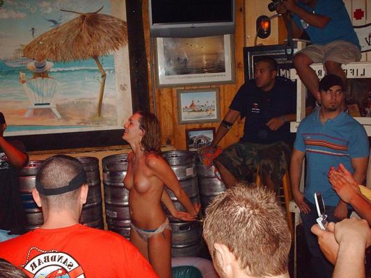 9P Two topless girls play-fighting in a bar