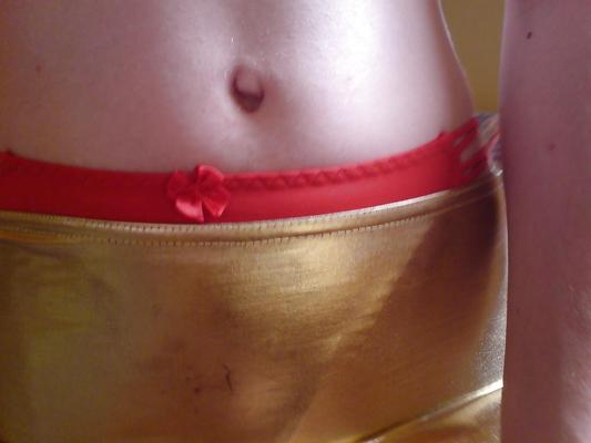 10P Sissy wears a gold mini skirt & bra