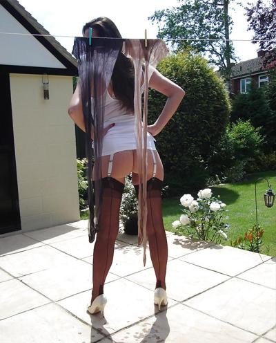 13P Strong lady in slip hangs washing