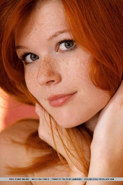 18P Redhead glamour model Mia Sollis posing in black lingerie in teasing manner