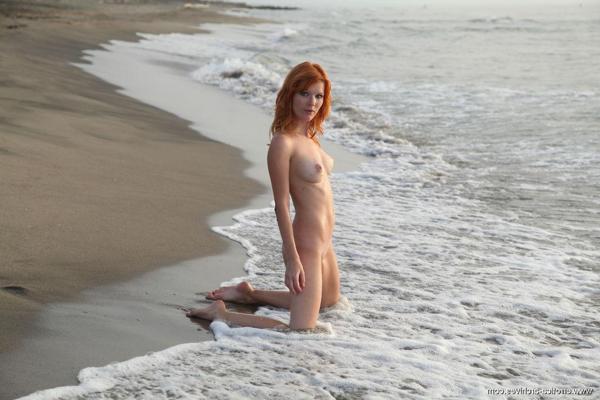 16P Beautiful redhead Mia Sollis has some naked fun on a public beach