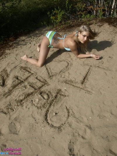 15P Pictures of teen porn girl Naughty Sarah stripping nude on a beach