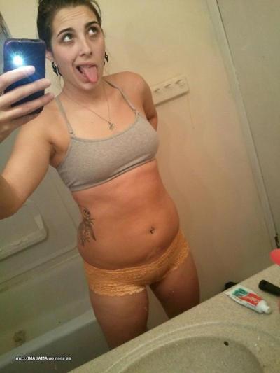 15P Horny brunette babe shows her breasts and pussy