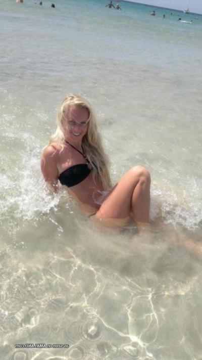 12P Photos of a sexy blonde babe posing in her black bikini