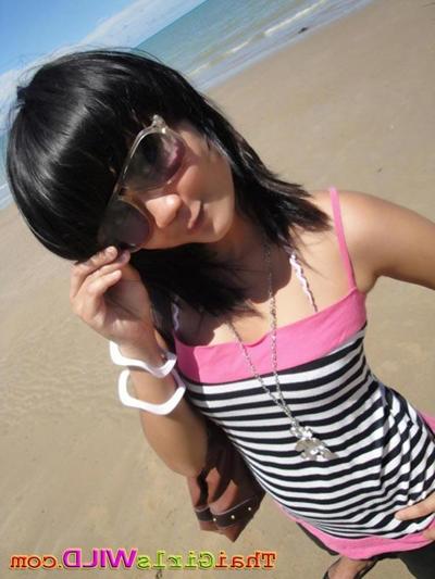16P Cute little Thai amateur Febe poses at the beach and flashes