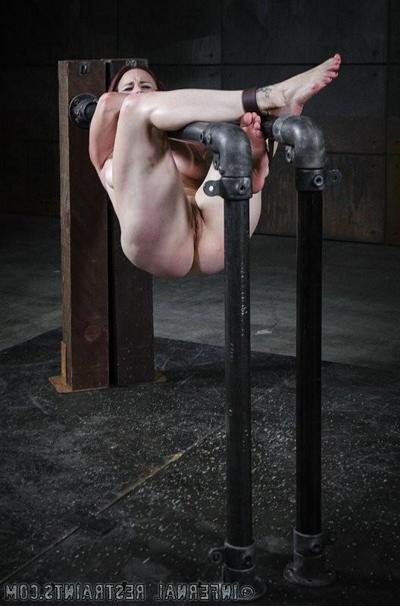14P Bella Rossi pantyhose redhead is bound between metal pipes in du