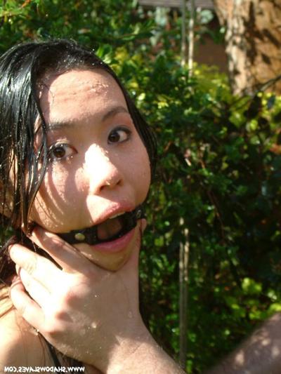 15P Oriental slave tied up outside and hosed down