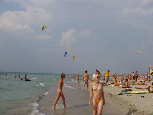 15P Brunette has some fun being nude on a public beach