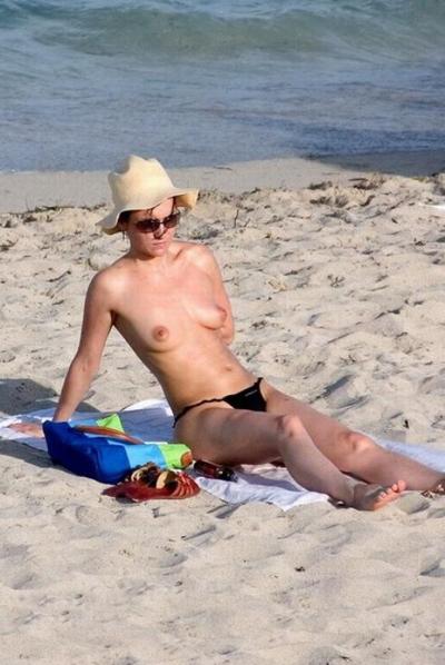15P Big breasted Russian girl shows off her privates on the sand