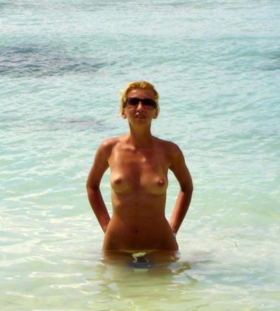 15P Brunette nudist strips down naked at a public beach