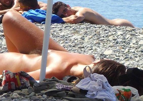 15P All eyes are on this young nudist as she sunbathes