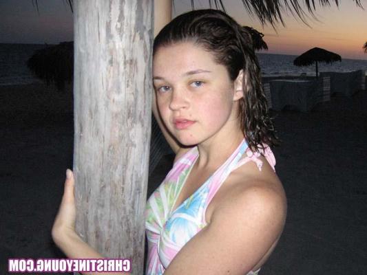 15P Amazing teen Christine Young flashing her tits on the beach