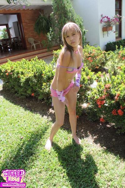 15P Brunette teen shows off her perky tits in the back yard