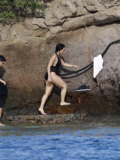 16P Demi Lovato showing her round ass in black swimsuit