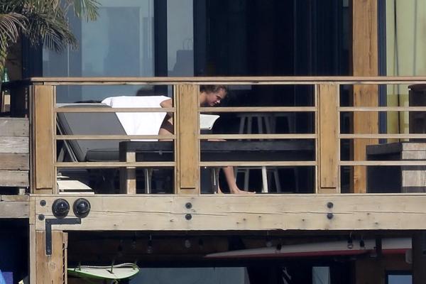 16P Cara Delevingne tanning topless on a balcony in Malibu