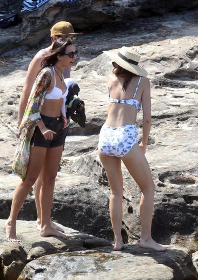 16P Demi Harman busty wearing a swimsuit on a rocky beach in Sydney