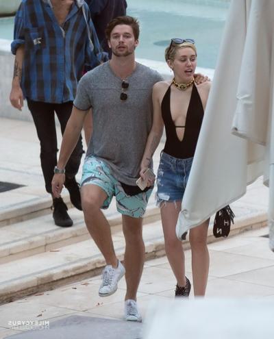 16P Miley Cyrus wearing swimsuit and hotpants at a pool in Miami