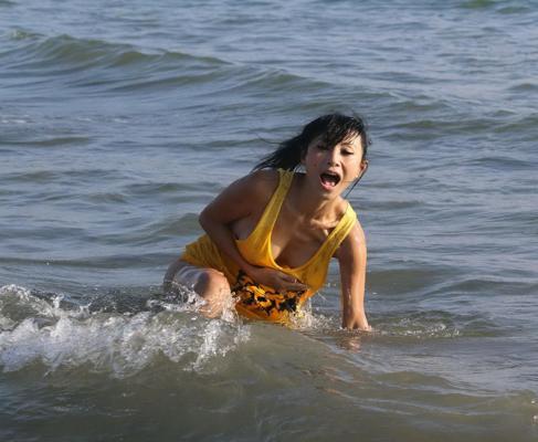 16P Bai Ling shows sideboob and pokies in wet tshirt and bikini bottom at the beach 