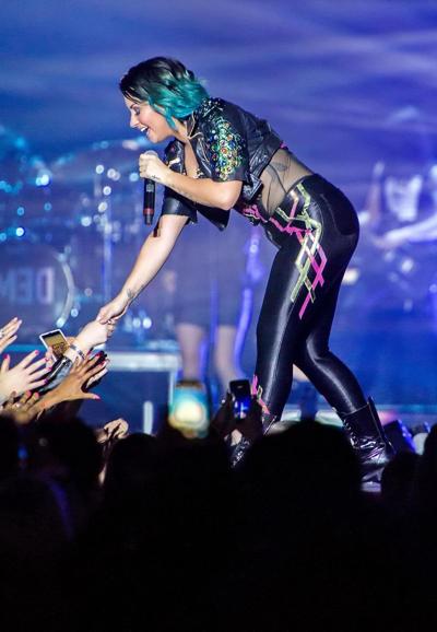 16P Demi Lovato wearing tights and spiky corset on stage in Birmingham