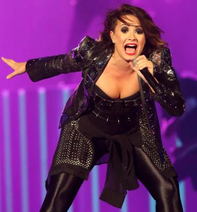 16P Demi Lovato in leather pants and metal corset performing on stage in Baltimore