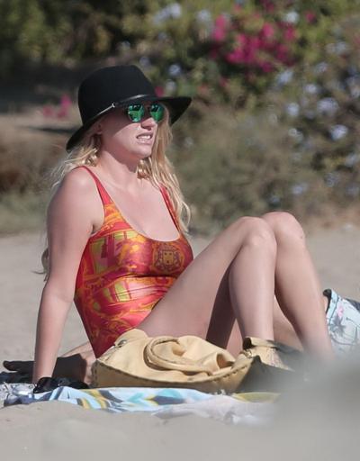 16P Kesha Sebert busty and booty in a red plunging swimsuit at the beach in Malibu