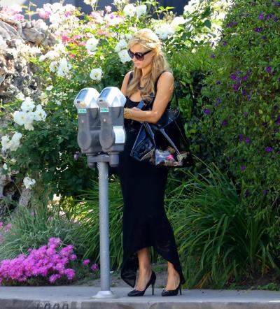 14P Paris Hilton shows huge cleavage wearing a low cut dress out in LA