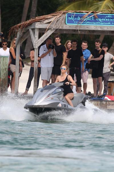 16P Charlize Theron jet skiing in black monokini during the photoshoot in Miami Beac