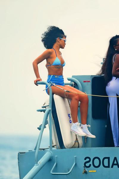 16P Rihanna showing off her hot body in a retro blue bikini at the beach in Barbados