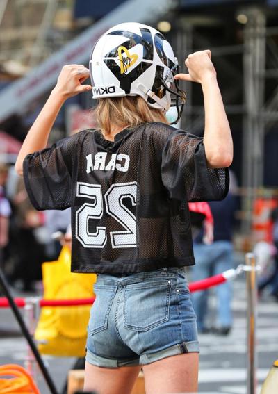 16P Cara Delevingne shows off her legs  ass wearing denim hotpants on the set of DKN