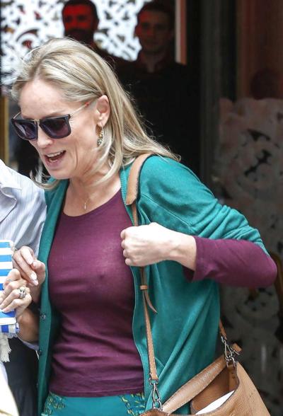 16P Sharon Stone exposing great boobs in see thru shirt on street