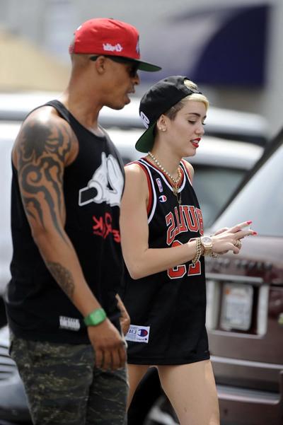 16P Miley Cyrus leggy wearing a shorts  a jersey outside a studio in LA