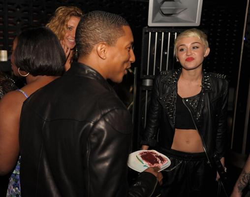 16P Miley Cyrus wears black belly top and leather shorts at Pharrell Williams's birt