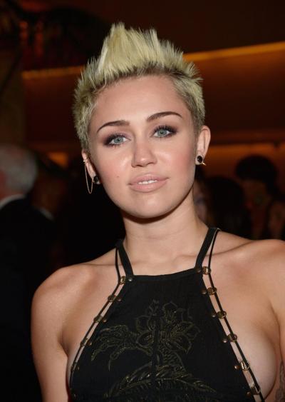 10P Miley Cyrus showing side boob in a black partially see-thru dress at Clive Davis