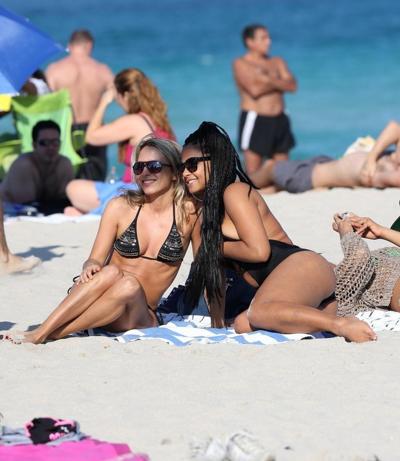 10P Christina Milian nipple slip wearing a skimpy black swimsuit in Miami Beach