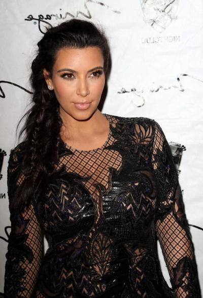10P Kim Kardashian in black fishnet dress hosting the New Year's Eve Countdown in La