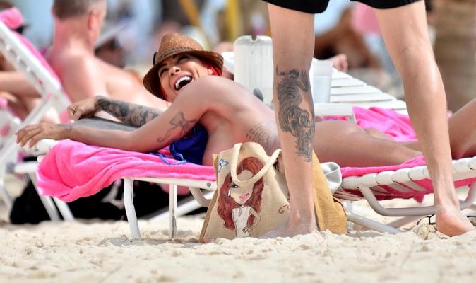 10P Busty Jodie Marsh tanning topless on a beach in Barbados